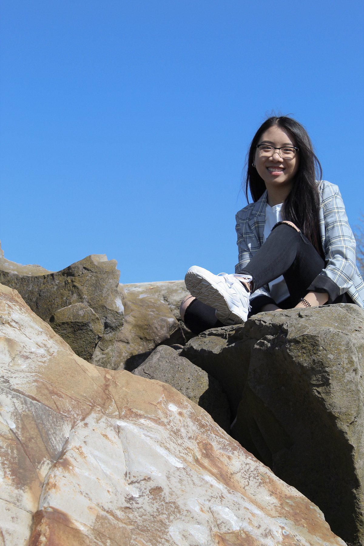 girl sitting on rock